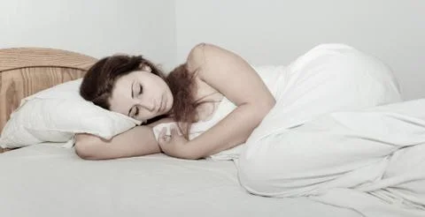 Beautiful girl sleeping in bed Stock Photos