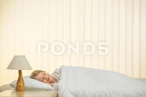 The beautiful girl sleeping on the bed Stock Photos