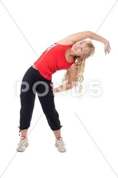 Beautiful girl in sportswear doing side bends. Stock Photos
