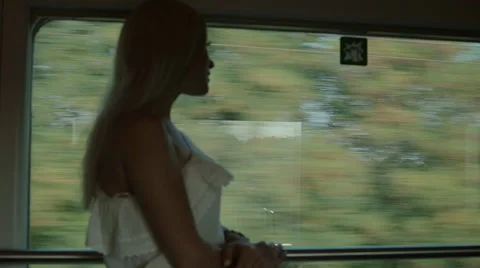 Beautiful girl standing by the window of the train Stock Footage 59804154