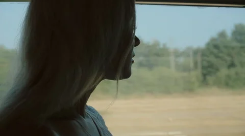 Beautiful girl standing by the window of the train Stock Footage 59804194