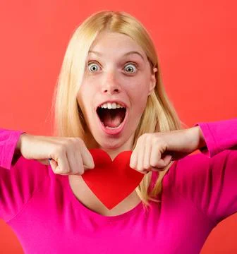 Beautiful girl tearing red paper heart. Break of relations. Relationships pro Stock Photos