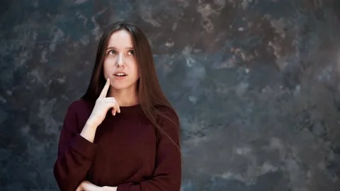 Beautiful girl is thinking about something. Medium shot with freespace for text Stock Footage 173740181