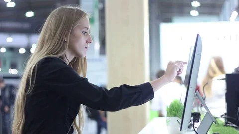 Beautiful girl using a large touch screen monitor Stock Footage 73011458