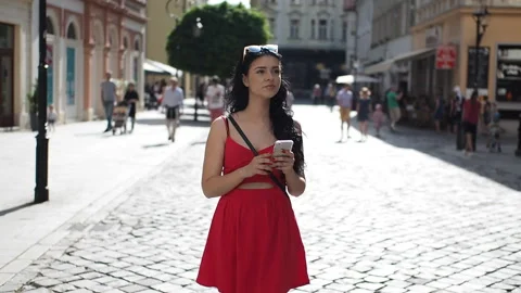 Beautiful girl using smartphone as navigation on street in SLOW MOTION HD VIDEO Stock Footage 131258758