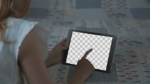 Beautiful girl using tablet pc with Isolated screen lying on bed at home  Stock Footage 63651312