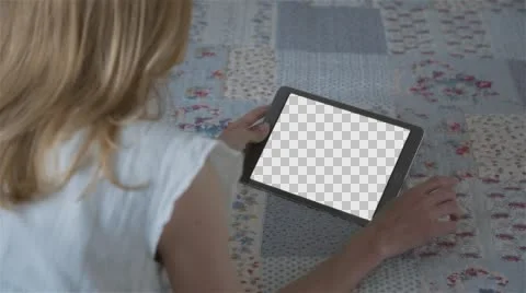 Beautiful girl using tablet pc with Isolated screen lying on bed at home  Stock Footage 63654595