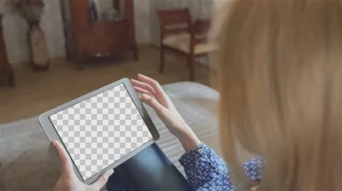 Beautiful girl using tablet pc with Isolated screen sitting on sofa at home 4 Video stock 64694778