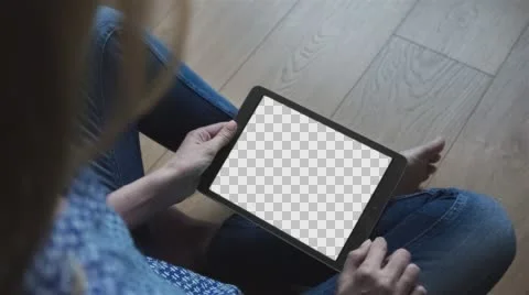 Beautiful girl using tablet pc with Isolated screen sitting on the floor  Stock Footage 64698720