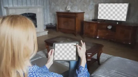 Beautiful girl using tablet pc with Isolated screen sitting on sofa at home 5 Stock Footage 64700360