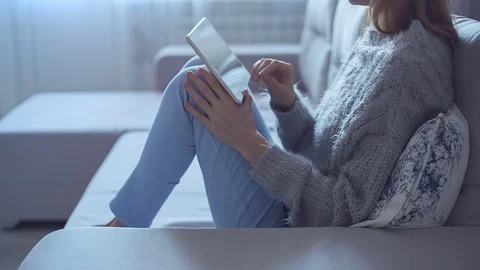 Beautiful Girl Using Tablet PC Sitting on Sofa Near Window 10 Stock Footage 72520808
