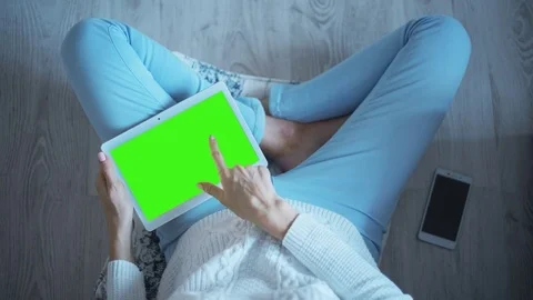 Beautiful Girl Using Tablet PC with Pre Keyed Green Screen Sitting on the Floor Stock Footage 72761994