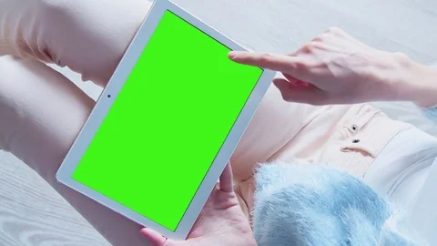 Beautiful Girl Using Tablet PC with Pre Keyed Green Screen Sitting on the Floor Stock Footage 73156860