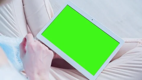 Beautiful Girl Using Tablet PC with Pre Keyed Green Screen Sitting on the Floor Stock Footage 73157469