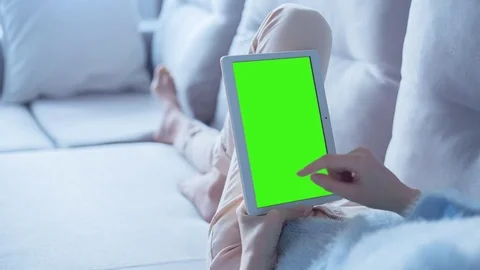 Beautiful Girl Using Tablet PC with Green Screen Laying on Sofa at Home 3 Stock Footage 73207465