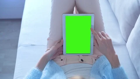 Beautiful Girl Using Tablet PC with Green Screen Laying on Sofa at Home 5 Stock Footage 73221995