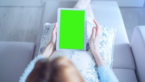 Beautiful Girl Using Tablet PC with Green Screen Laying on Sofa at Home 6 Stock Footage 73222094