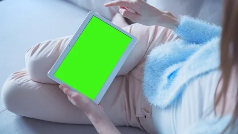 Beautiful Girl Using Tablet PC with Green Screen Laying on Sofa at Home 13 Stock Footage 73273107