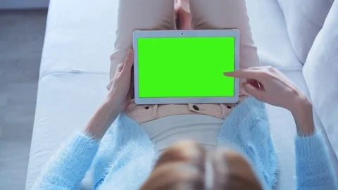 Beautiful Girl Using Tablet PC with Green Screen Laying on Sofa at Home 9 Stock Footage 73273842