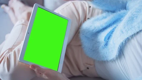 Beautiful Girl Using Tablet PC with Green Screen Laying on Sofa at Home 14 Stock Footage 73285328
