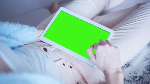 Beautiful Girl Using Tablet PC with Green Screen Laying on Sofa at Home 17 Stock Footage 73328549