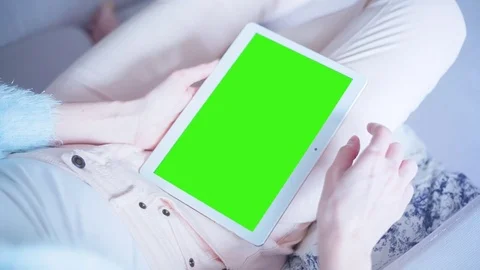 Beautiful Girl Using Tablet PC with Green Screen Laying on Sofa at Home 18 Stock Footage 73339023