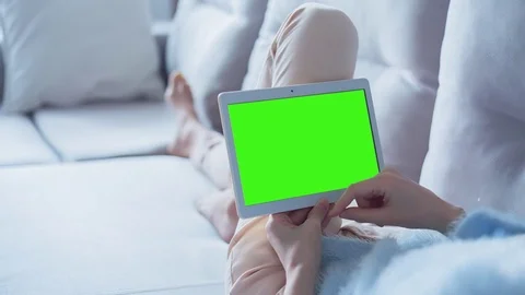 Beautiful Girl Using Tablet PC with Green Screen Laying on Sofa at Home 20 Stock Footage 73372352