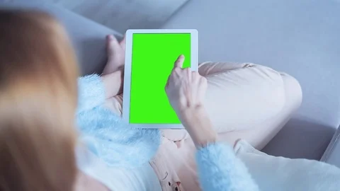 Beautiful Girl Using Tablet PC with Green Screen Laying on Sofa at Home 21 Stock Footage 73372844