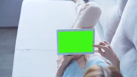 Beautiful Girl Using Tablet PC with Green Screen Laying on Sofa at Home 22 Stock Footage 73402507