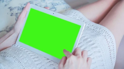 Beautiful Girl Using Tablet PC with Green Screen Laying on Sofa at Home 23 Stock Footage 73756632