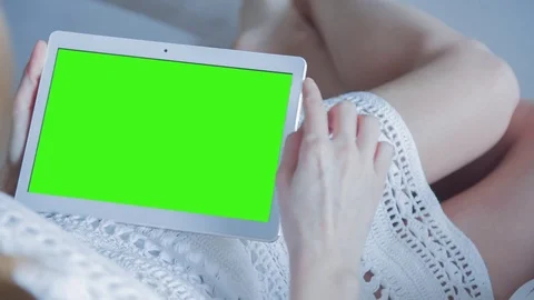 Beautiful Girl Using Tablet PC with Green Screen Laying on Sofa at Home 27 Stock Footage 73783959