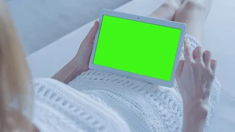 Beautiful Girl Using Tablet PC with Green Screen Laying on Sofa at Home 25 Stock Footage 73802008