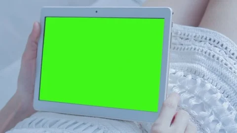 Beautiful Girl Using Tablet PC with Green Screen Laying on Sofa at Home Stock Footage 73826278