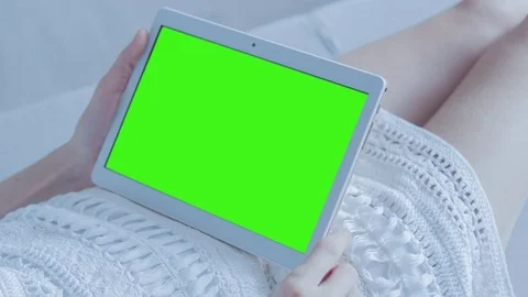 Beautiful Girl Using Tablet PC with Green Screen Laying on Sofa at Home Stock Footage 73826843