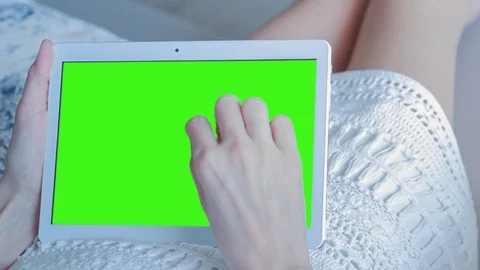 Beautiful Girl Using Tablet PC with Green Screen Laying on Sofa at Home Stock Footage 73844498