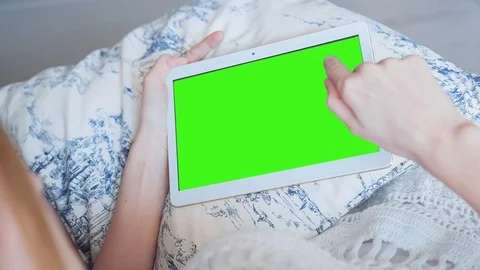 Beautiful Girl Using Tablet PC with Green Screen Laying on Sofa at Home 30 Stock Footage 73883115