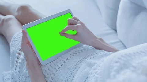 Beautiful Girl Using Tablet PC with Green Screen Laying on Sofa at Home 32 Stock Footage 73884080