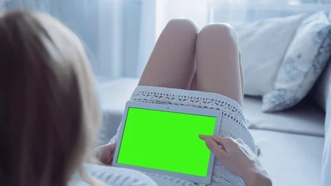 Beautiful Girl Using Tablet PC with Green Screen Laying on Sofa at Home 33 Stock Footage 74142343