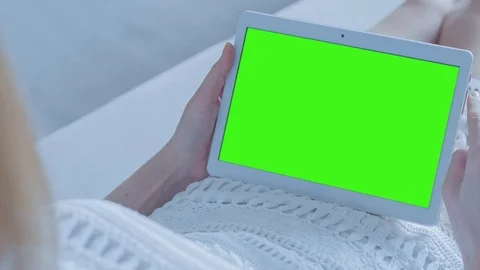 Beautiful Girl Using Tablet PC with Green Screen Laying on Sofa at Home Stock Footage 74142927