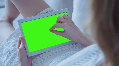 Beautiful Girl Using Tablet PC with Green Screen Laying on Sofa at Home 35 Stock Footage 74175866