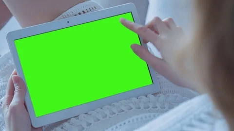 Beautiful Girl Using Tablet PC with Green Screen Laying on Sofa at Home Stock Footage 74249244