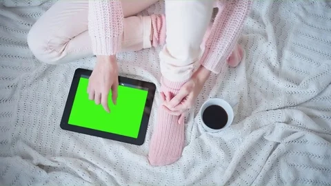 Beautiful Girl Using Tablet PC with Pre-Keyed Green Screen Sitting on the Floor Stock Footage 74313626