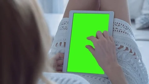 Beautiful Girl Using Tablet PC with Green Screen Laying on Sofa at Home Stock Footage 74488584