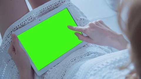 Beautiful Girl Using Tablet PC with Green Screen Laying on Sofa at Home 37 Stock Footage 74493429