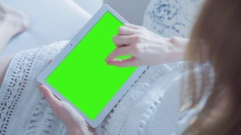 Beautiful Girl Using Tablet PC with Green Screen Laying on Sofa at Home 38 Stock Footage 74493994