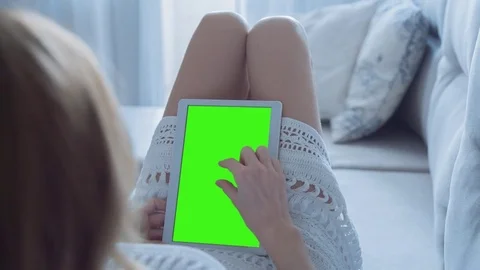 Beautiful Girl Using Tablet PC with Green Screen Laying on Sofa at Home 39 Stock Footage 74496109