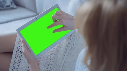 Beautiful Girl Using Tablet PC with Green Screen Laying on Sofa at Home 40 Stock Footage 74497051