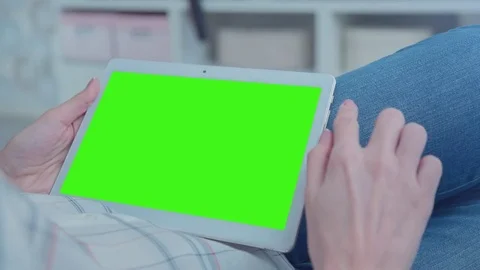 Beautiful Girl Using Tablet PC with Green Screen Laying on Sofa at Home 41 Stock Footage 74899358