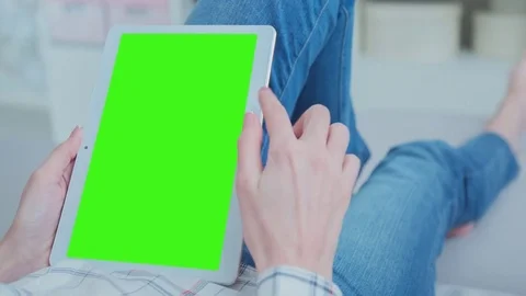 Beautiful Girl Using Tablet PC with Green Screen Laying on Sofa at Home 42 Video stock 74905384