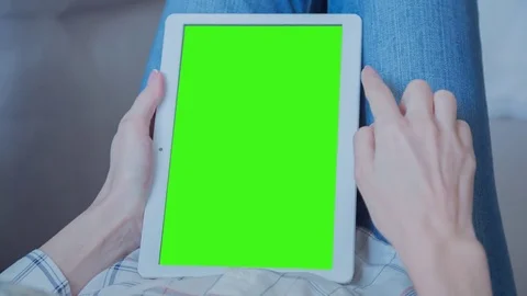 Beautiful Girl Using Tablet PC with Green Screen Laying on Sofa at Home 44 Stock Footage 74923080
